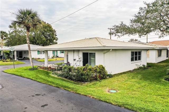 view of property exterior featuring a lawn