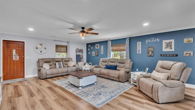 living room with ceiling fan, crown molding, and light hardwood / wood-style flooring