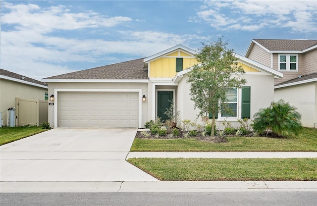 view of front of property with a front yard and a garage