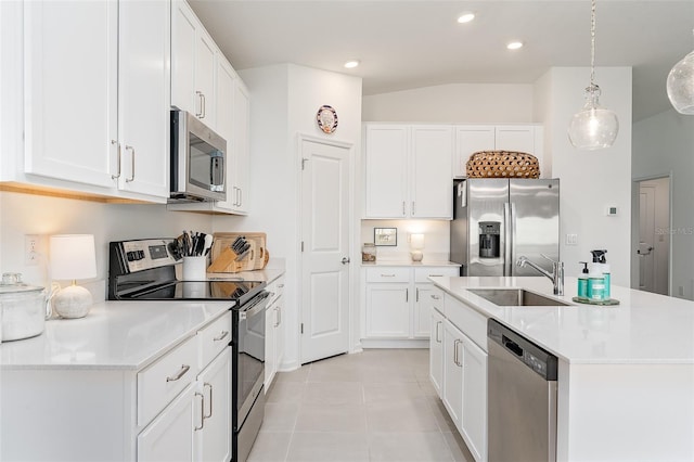 kitchen with appliances with stainless steel finishes, sink, decorative light fixtures, white cabinets, and light tile patterned floors