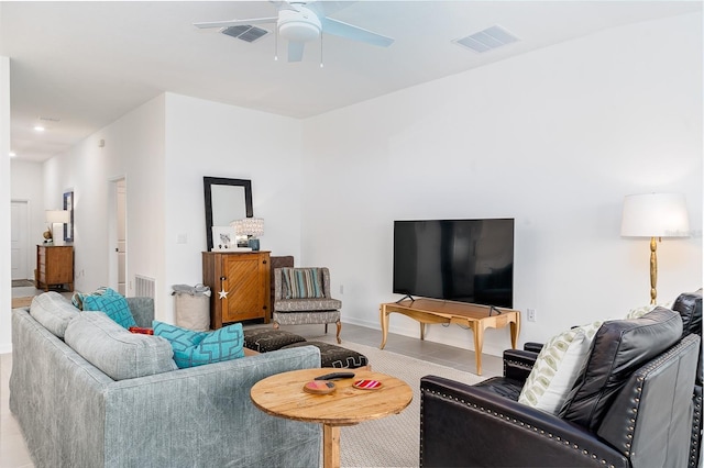 living room featuring light tile patterned floors and ceiling fan