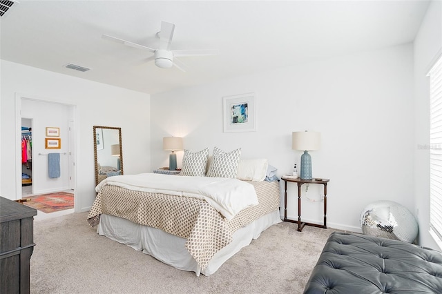 bedroom featuring ceiling fan, light colored carpet, and multiple windows