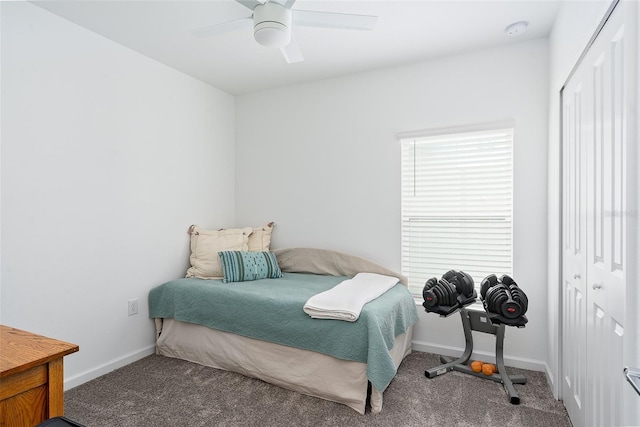 carpeted bedroom featuring ceiling fan and a closet