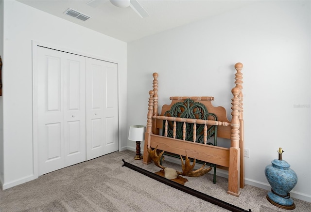 bedroom featuring ceiling fan, a closet, and light carpet