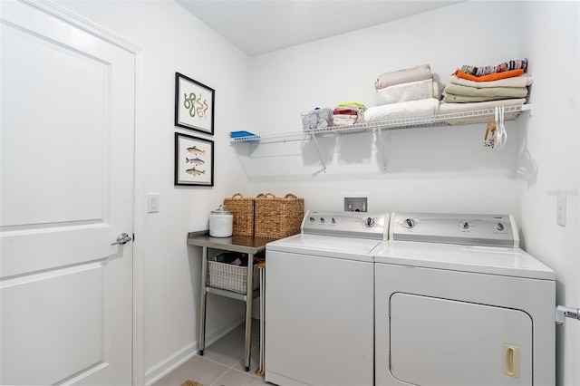 laundry area with light tile patterned floors and independent washer and dryer