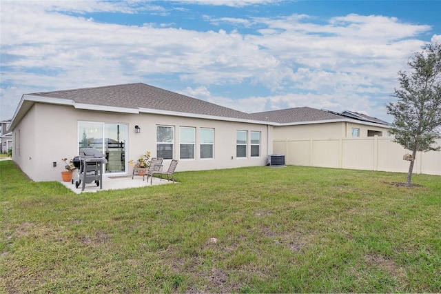 rear view of house featuring a patio area, central AC unit, and a lawn