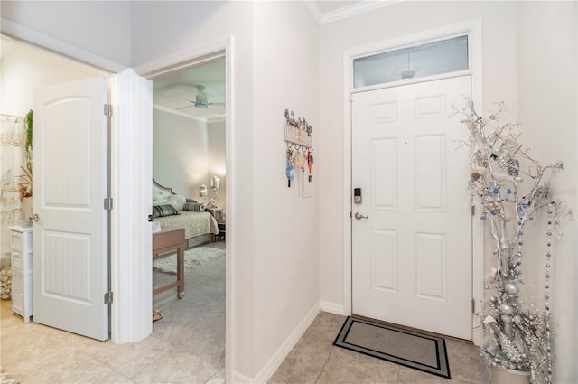 entryway with ceiling fan and ornamental molding