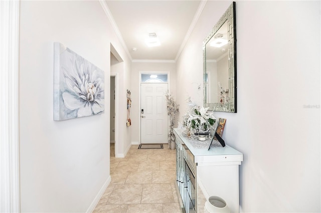 entryway with light tile patterned floors and ornamental molding