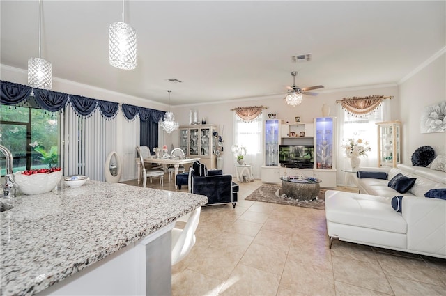 tiled living room featuring ceiling fan and ornamental molding