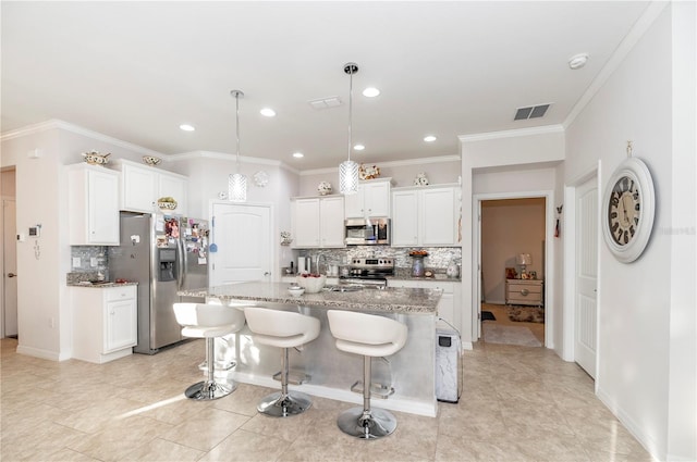 kitchen with white cabinets, backsplash, stainless steel appliances, and an island with sink