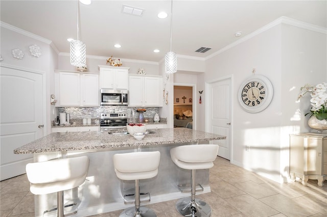 kitchen featuring white cabinetry, an island with sink, and appliances with stainless steel finishes