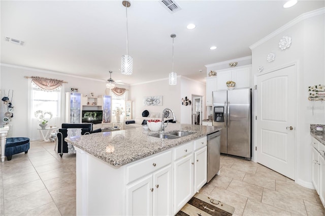 kitchen with a kitchen island with sink, white cabinets, ceiling fan, light stone countertops, and appliances with stainless steel finishes