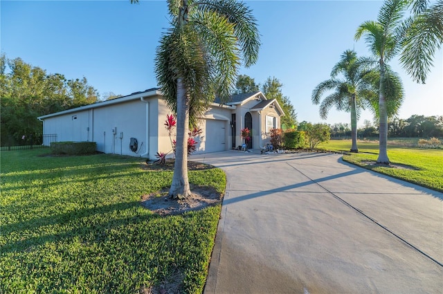 single story home featuring a front yard and a garage