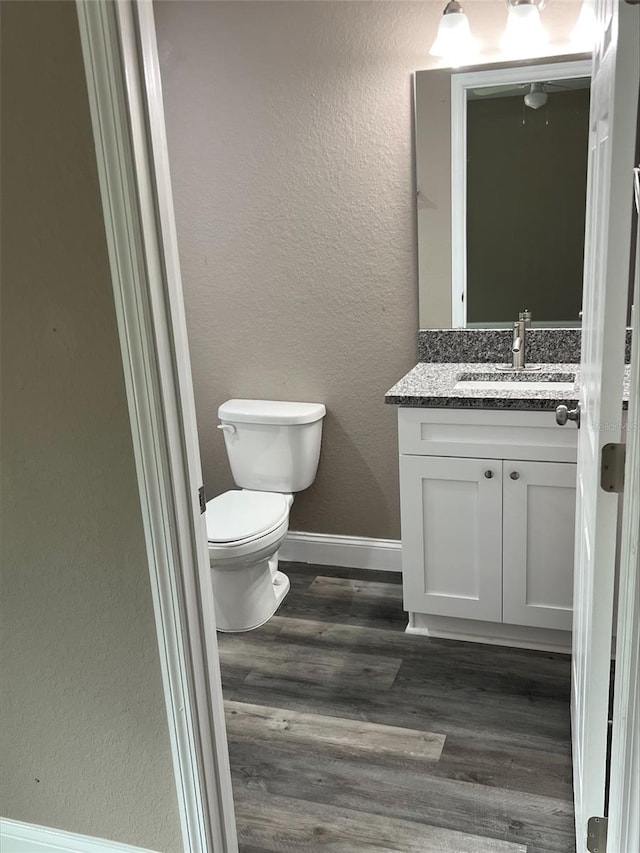 bathroom featuring hardwood / wood-style floors, toilet, and vanity