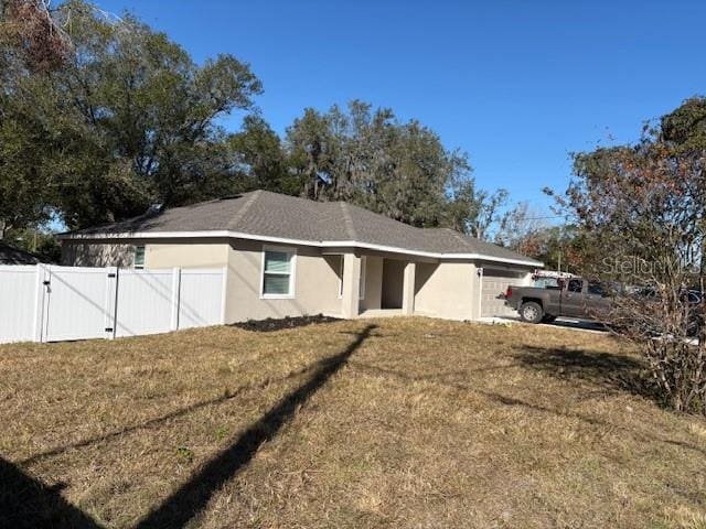 exterior space with a garage and a yard