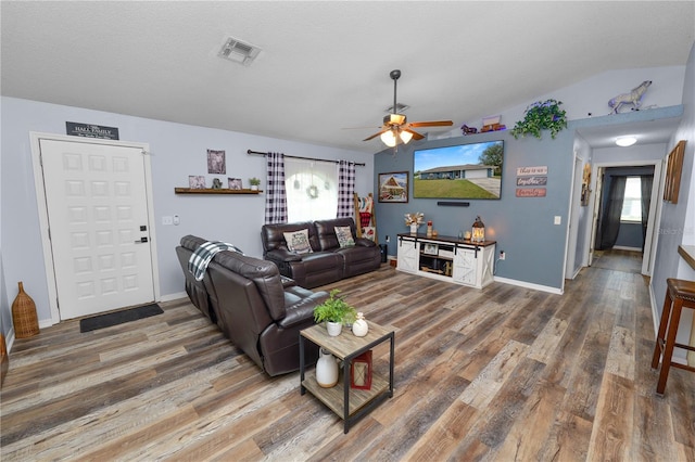 living room featuring a textured ceiling, dark hardwood / wood-style floors, ceiling fan, and lofted ceiling