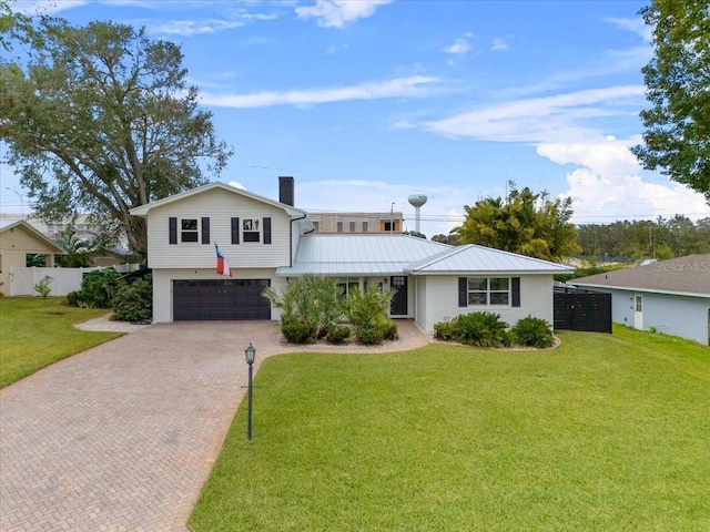 view of front of house featuring a garage and a front lawn