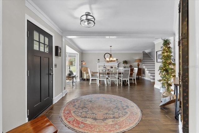 entryway with a notable chandelier, dark hardwood / wood-style floors, and ornamental molding