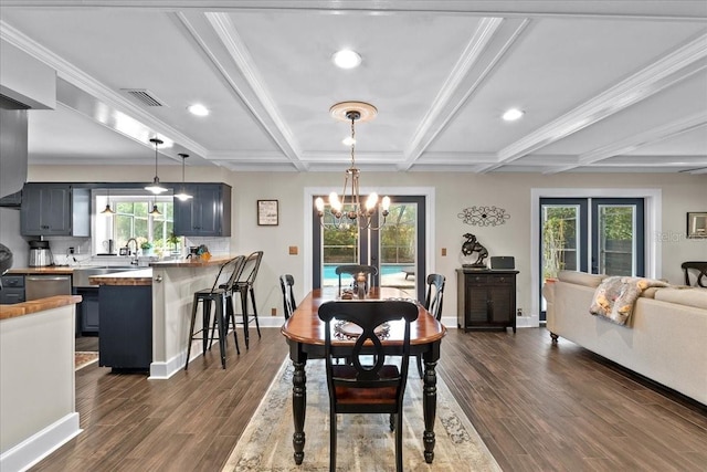 dining area with an inviting chandelier, beamed ceiling, and ornamental molding