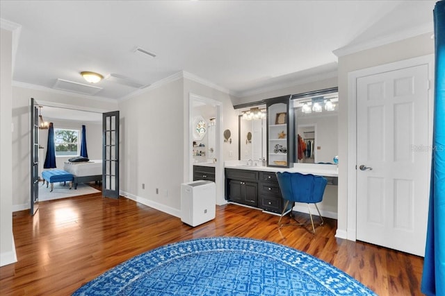 bathroom with crown molding, vanity, and wood-type flooring