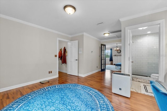 living area with wood-type flooring and ornamental molding