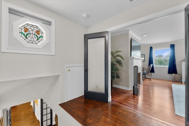 entrance foyer featuring french doors, ornamental molding, and hardwood / wood-style flooring