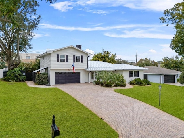 view of front of house featuring a front yard and a garage