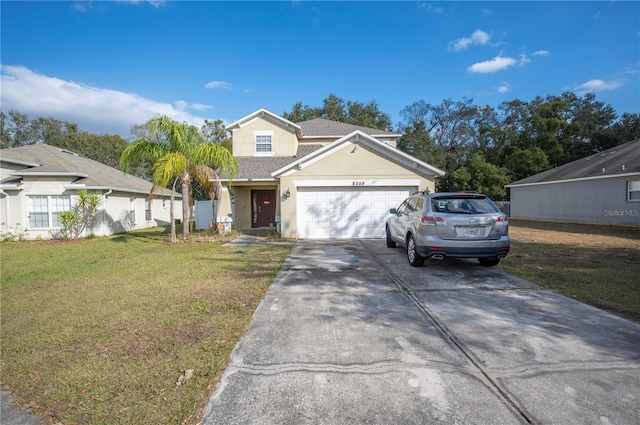 view of front of home with a front yard and a garage