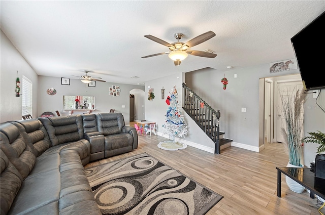 living room with light wood-type flooring and ceiling fan