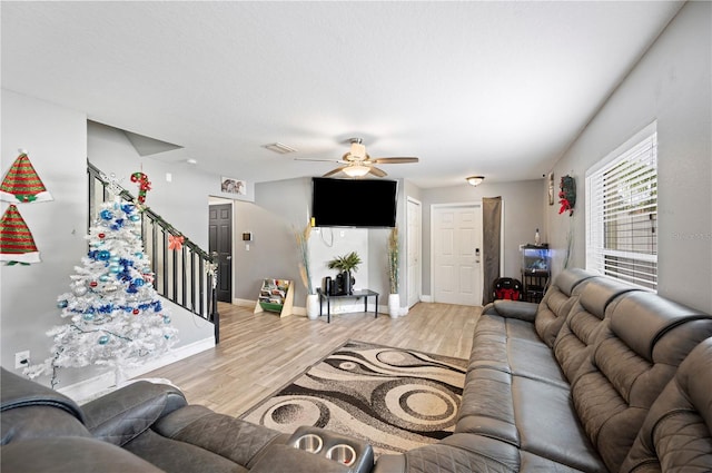 living room featuring ceiling fan and light hardwood / wood-style flooring