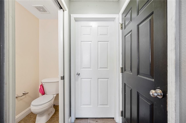 bathroom with tile patterned flooring and toilet