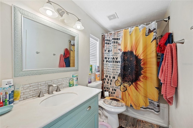 full bathroom with shower / bath combo, toilet, vanity, and tasteful backsplash