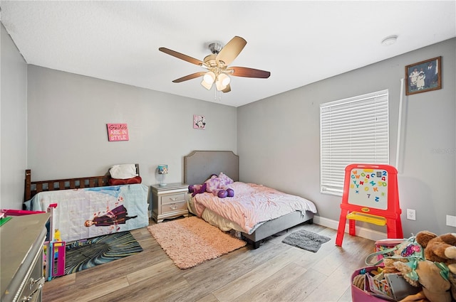 bedroom with hardwood / wood-style flooring and ceiling fan