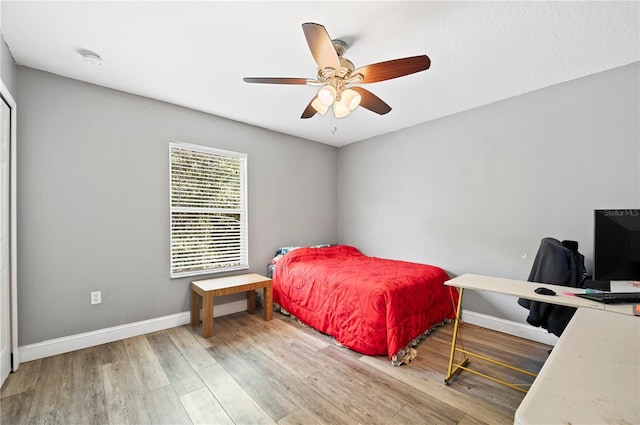 bedroom featuring hardwood / wood-style floors and ceiling fan