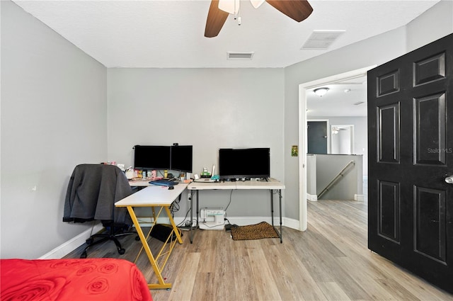 office with ceiling fan and light hardwood / wood-style flooring