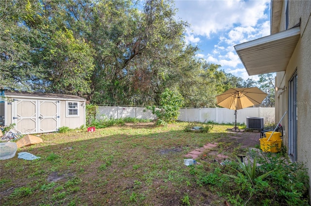 view of yard with cooling unit and a shed