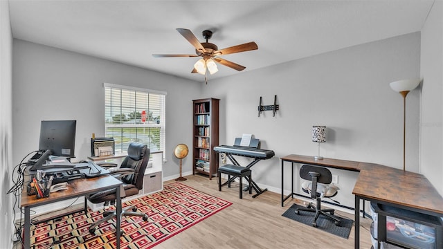 home office with ceiling fan and light hardwood / wood-style floors