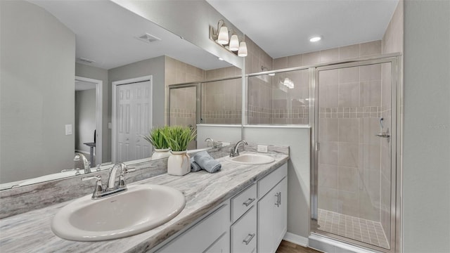 bathroom featuring walk in shower and vanity