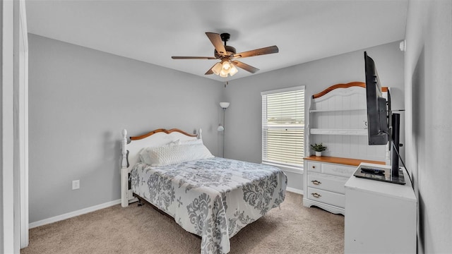 bedroom with ceiling fan, multiple windows, and light carpet