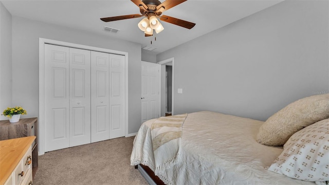 carpeted bedroom with ceiling fan and a closet