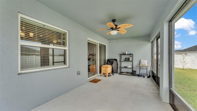 sunroom / solarium featuring ceiling fan