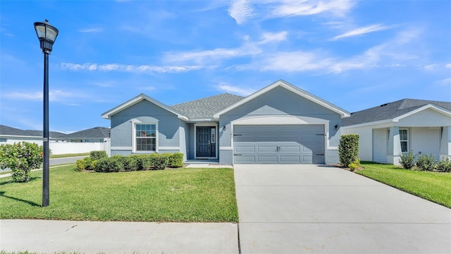 ranch-style house with a garage, stucco siding, driveway, and a front lawn