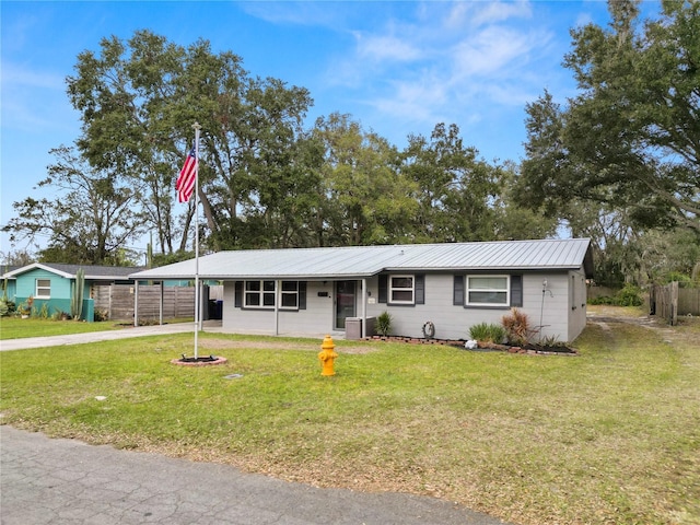 ranch-style home featuring a front yard and central AC unit