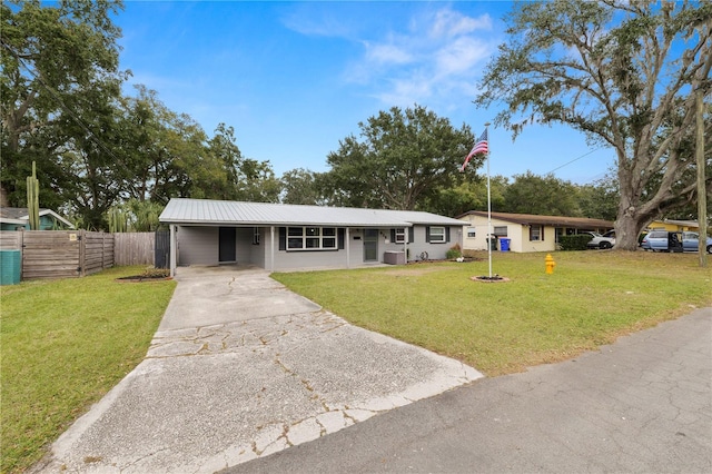 ranch-style house with central AC unit, a carport, and a front yard