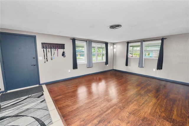 spare room featuring dark wood-type flooring and a textured ceiling