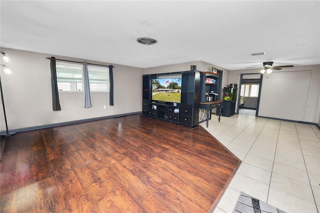 cinema room featuring ceiling fan, tile patterned flooring, and a textured ceiling