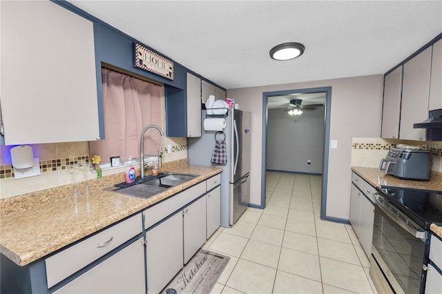 kitchen featuring exhaust hood, light tile patterned floors, ceiling fan, stainless steel appliances, and sink