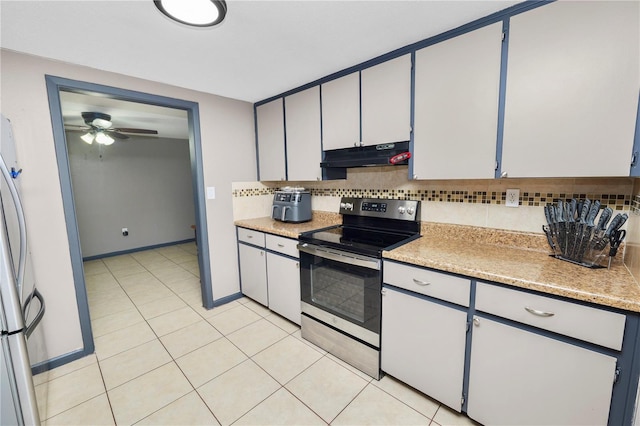 kitchen featuring white cabinets, appliances with stainless steel finishes, tasteful backsplash, ceiling fan, and light tile patterned floors