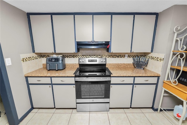 kitchen featuring light tile patterned floors, decorative backsplash, and electric range