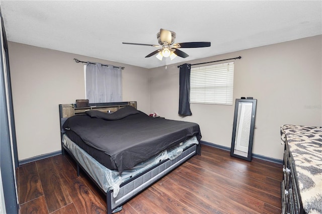 bedroom featuring ceiling fan, dark wood-type flooring, and a textured ceiling